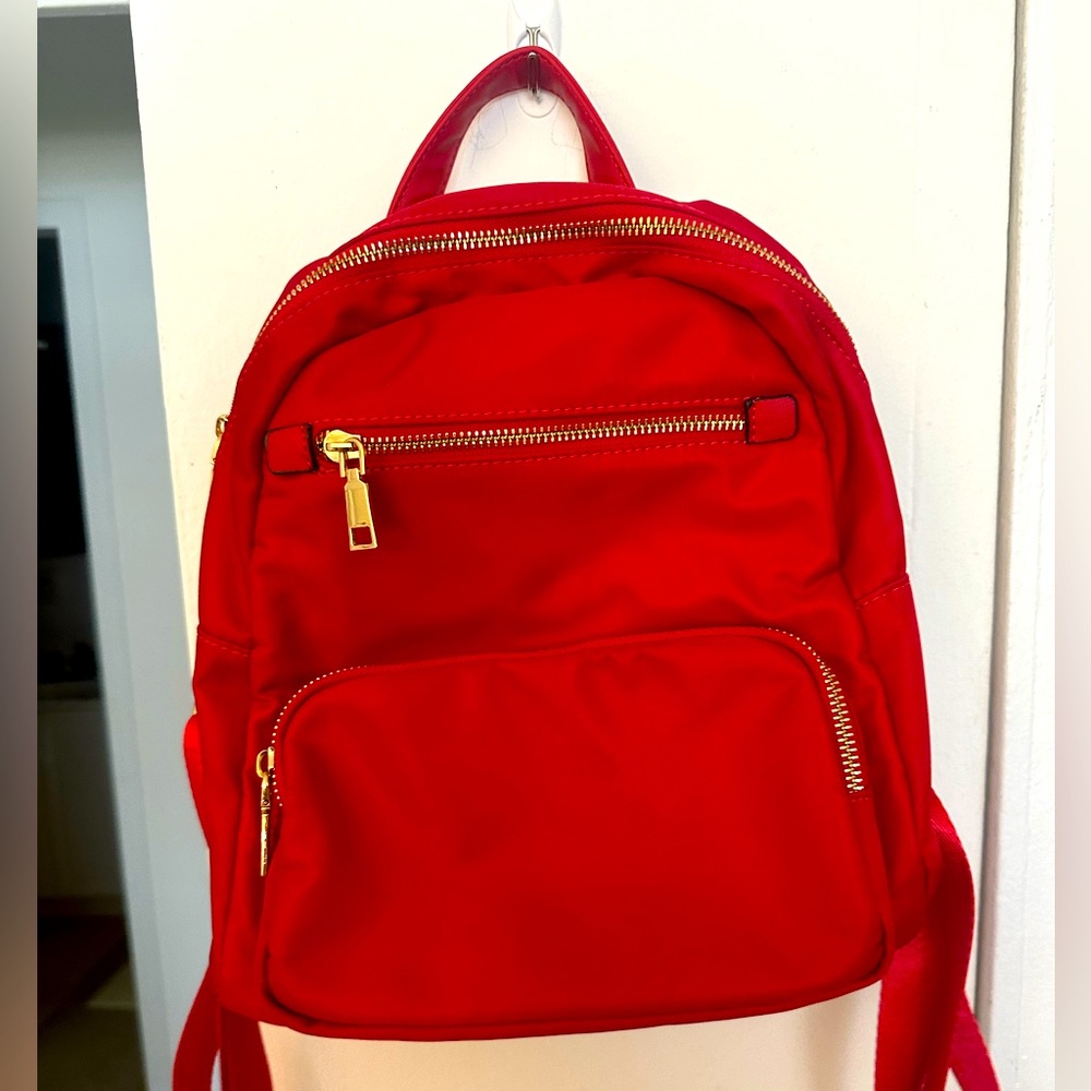 EUC red backpack. Perfect for daily or travel use holding essentials.